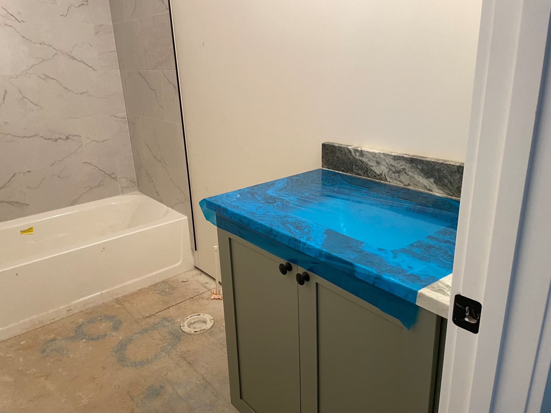 Bathroom with wall tile and tub at 8005 Sherbeyn Road