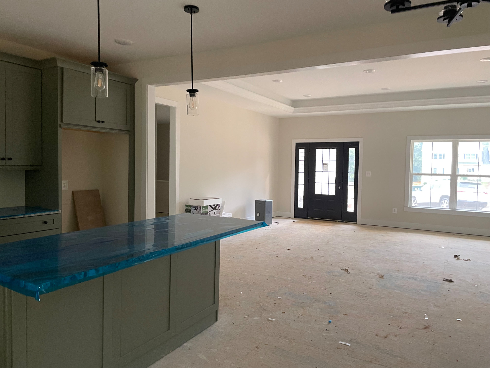 Great room with tray ceiling and kitchen island at 8005 Sherbeyn Road